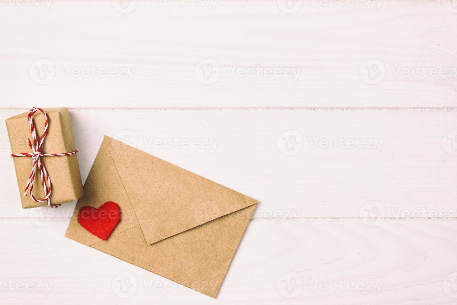 Valentine with red heart. A paper parcel wrapped tied toned, vintage. A red heart with gift box wrapped with paper kraft photo