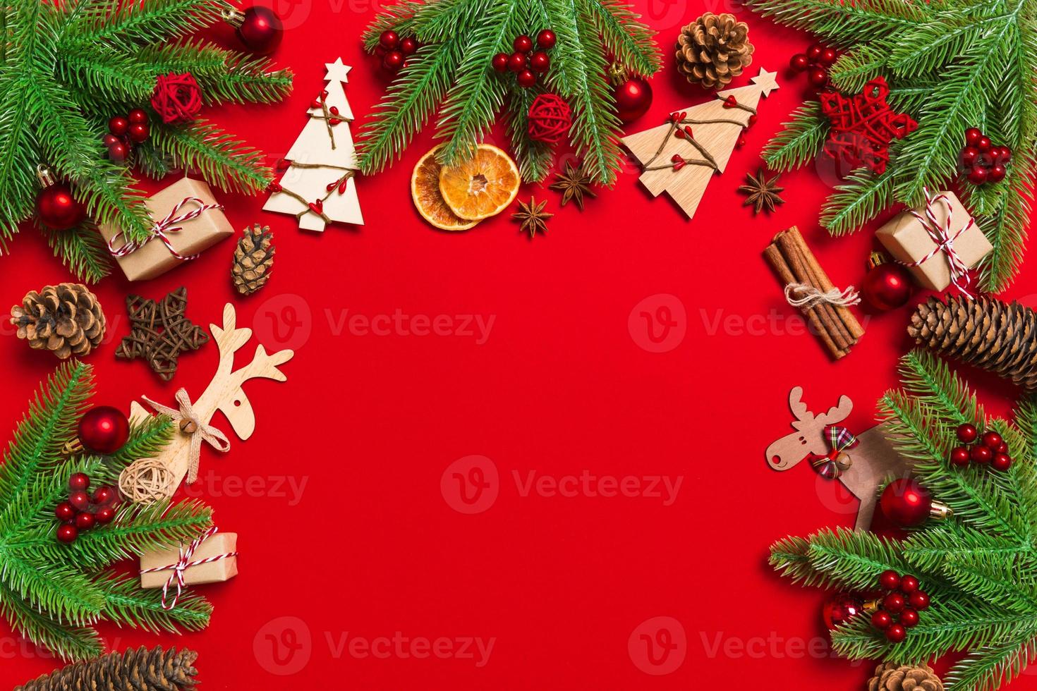 Top view of Christmas decorations on red background. New Year holiday concept with copy space photo