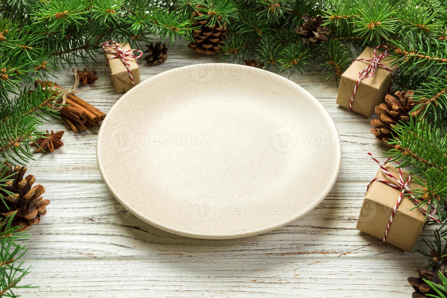 Perspective view. Empty plate round ceramic on wooden christmas background. holiday dinner dish concept with new year decor photo