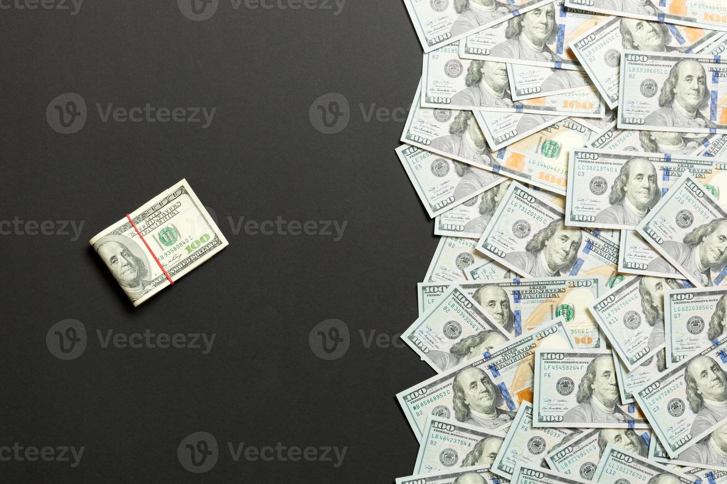 Heap of hundred Dollar Bills on colored background top view, with empty place for your text business money concept photo