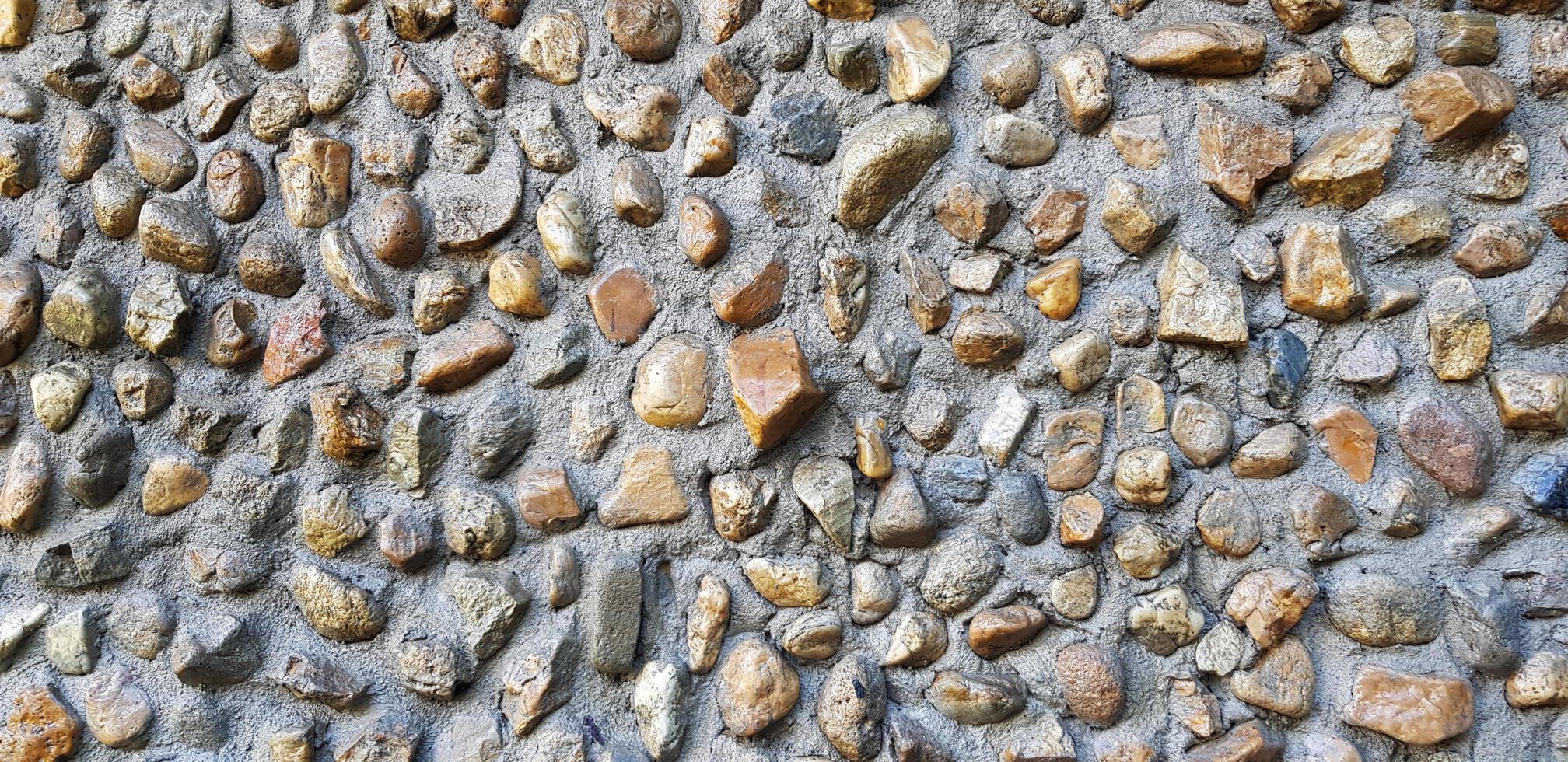 Gravel stone or hard rock pattern wall for background. Exterior structure design in loft style and Natural art of wallpaper concept photo