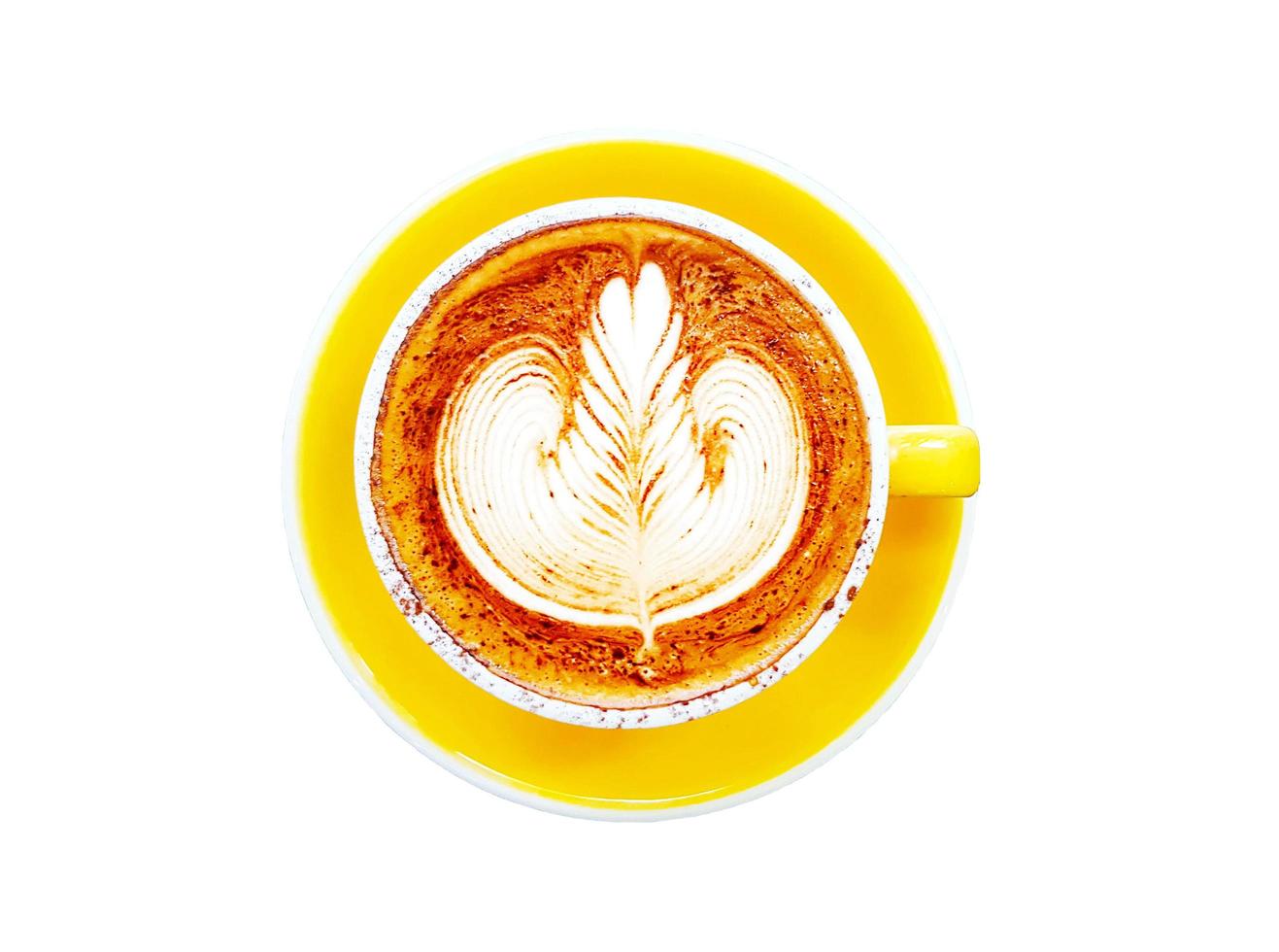 Top view of cup of art cappuccino or latte coffee isolated on white background with clipping path and make selection. Flat lay of hot drinking in yellow glass and bottom plate. Food design concept. photo