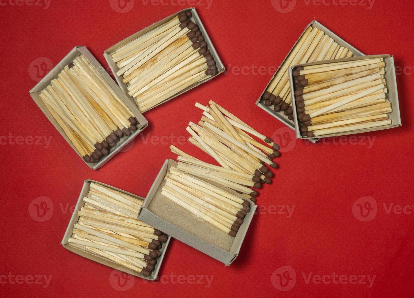 Matchsticks  on a red background. Safe handling of fire. Fire dangers. Lots of matches.  still life. Matchsticks  boxes photo