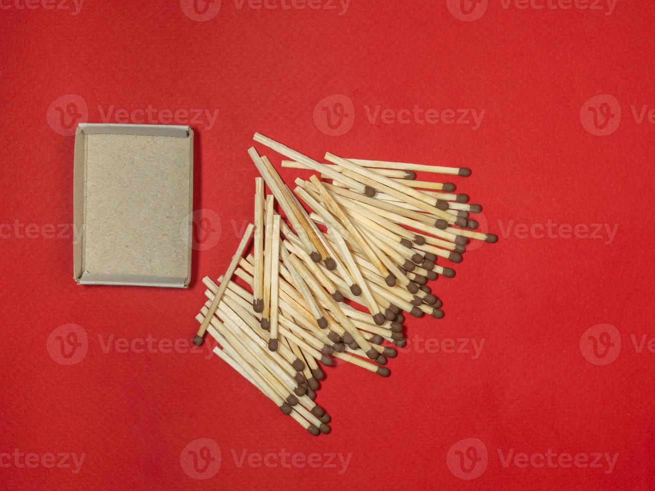 Matchsticks on a red background. Safe handling of fire. Fire dangers. Lots of matches.  household still life photo