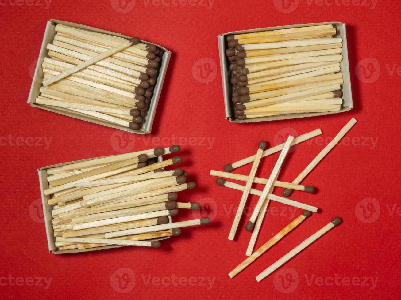 Matches on a red background. Safe handling of fire. Fire dangers. Lots of matches. photo