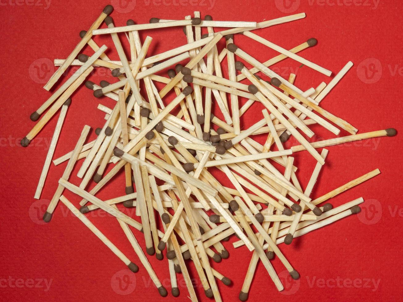 Matchsticks on a red background. Safe handling of fire. Fire dangers. Lots of matches.  household still life photo