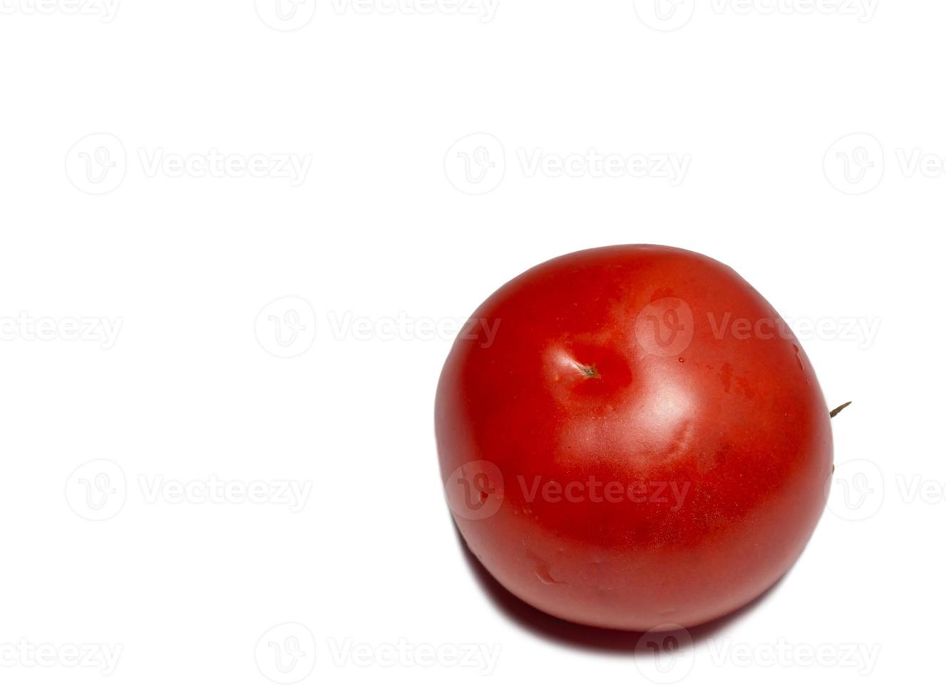 Greenhouse tomato on a white background. Ripe vegetable. Tomato isolate. Vegetables in water drops photo