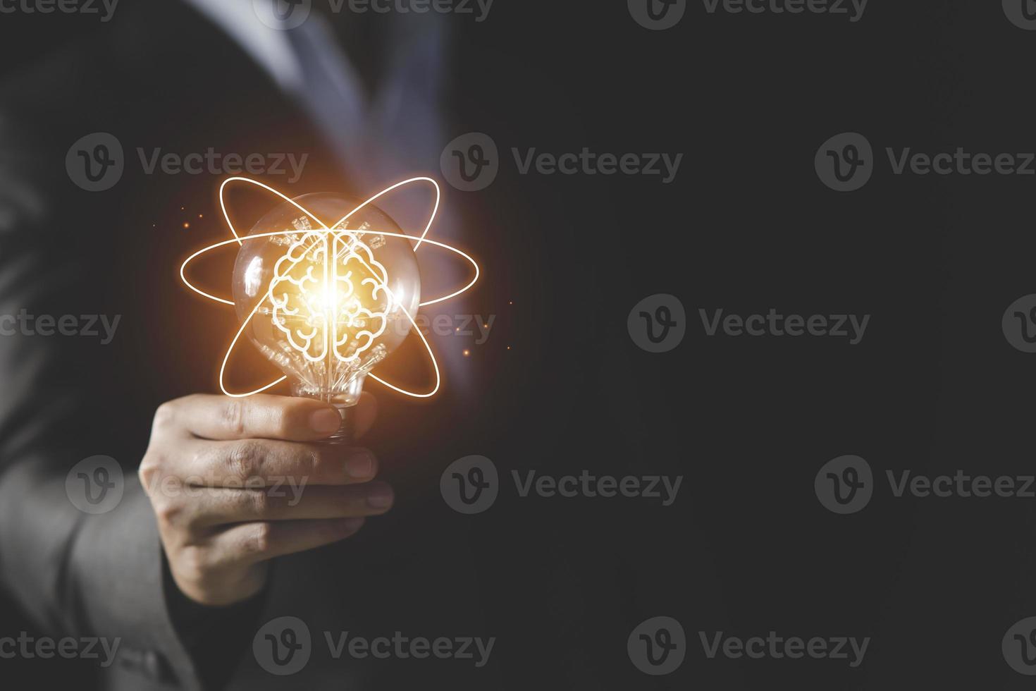 Businessman holding light bulb and brain icon inside, Futuristic businesss Ideas concept, Creative, inspiration, and innovation with network connection. Development innovative technology photo