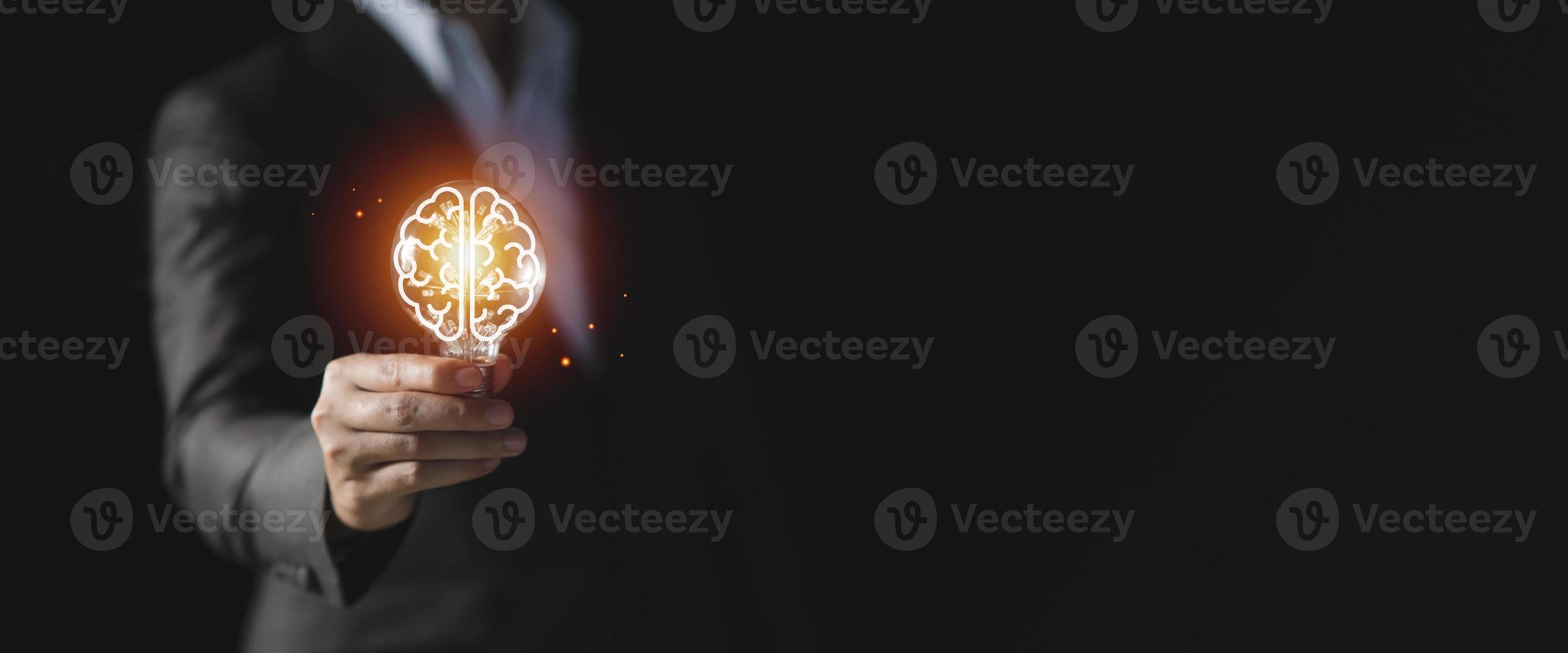 Businessman holding light bulb with brain icon inside, Futuristic businesss Ideas concept, Creative, inspiration, and innovation with network connection. Development innovative technology photo