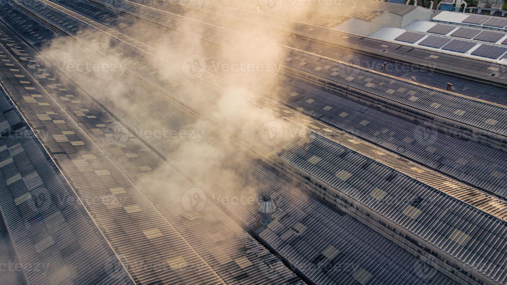 Toxic fumes spread from the roof of an industrial plant. Industrial plants emit large amounts of smoke from the factories during production. which creates air pollution for the world. photo