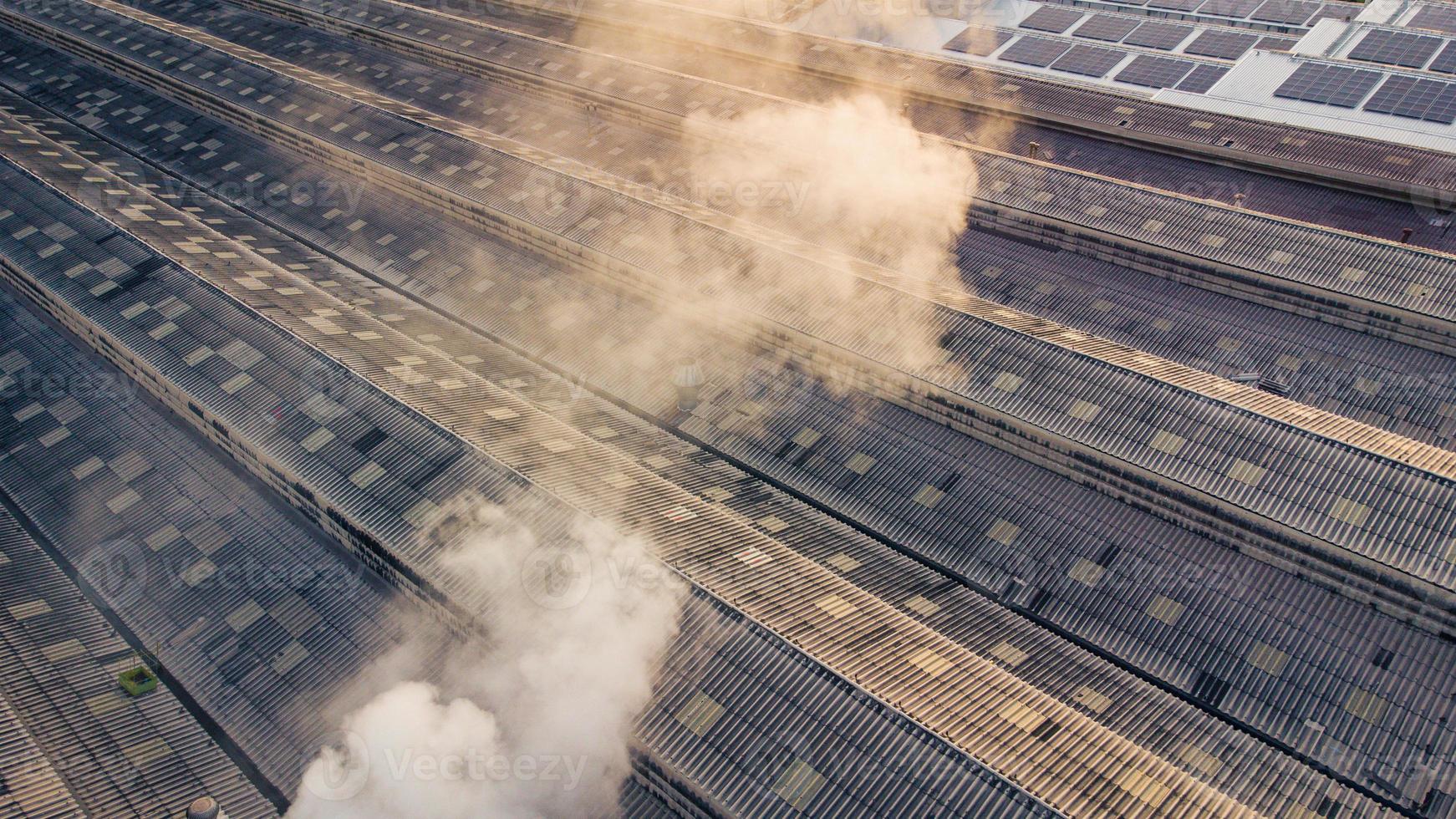 Toxic fumes spread from the roof of an industrial plant. Industrial plants emit large amounts of smoke from the factories during production. which creates air pollution for the world. photo