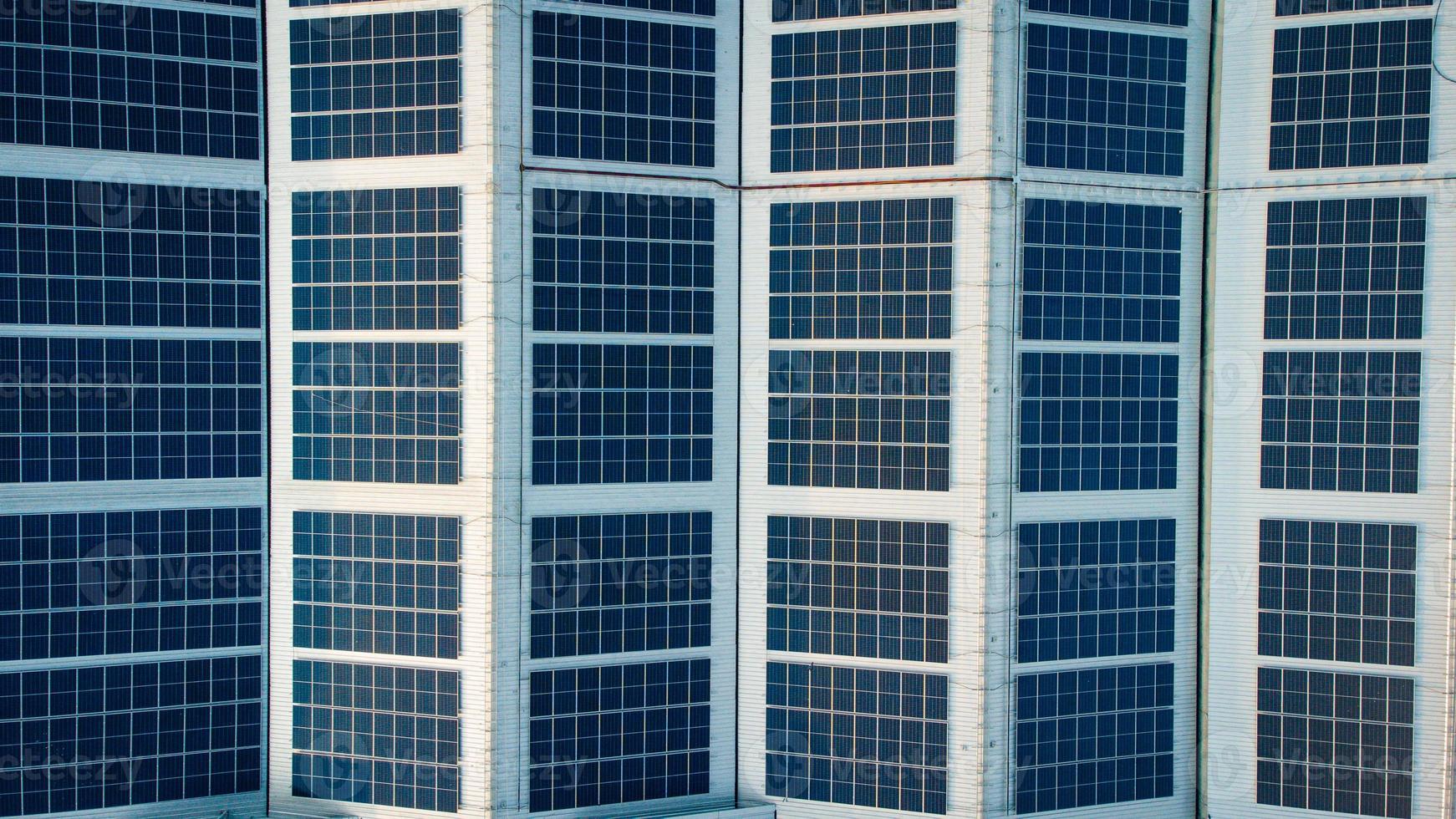 Solar cells on the solar farms of a large industrial factory. Solar farms are generating renewable energy for the industry. The goal is to reduce the cost of electricity. photo