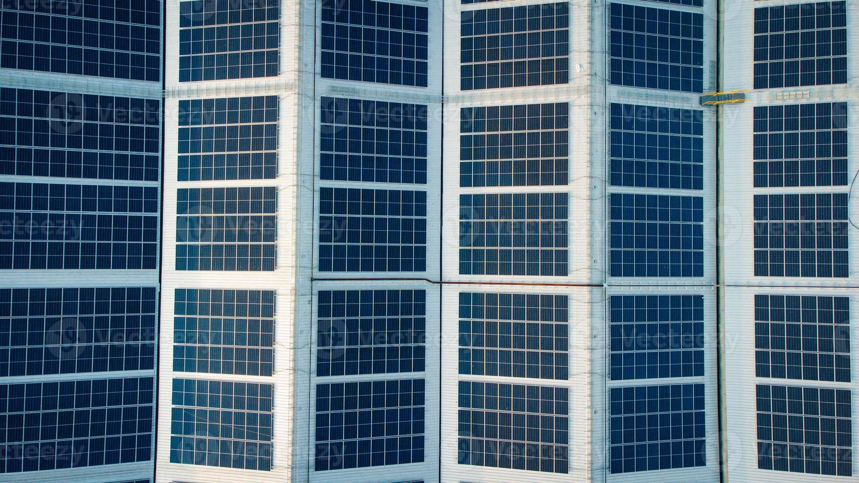 Solar cells on the solar farms of a large industrial factory. Solar farms are generating renewable energy for the industry. The goal is to reduce the cost of electricity. photo