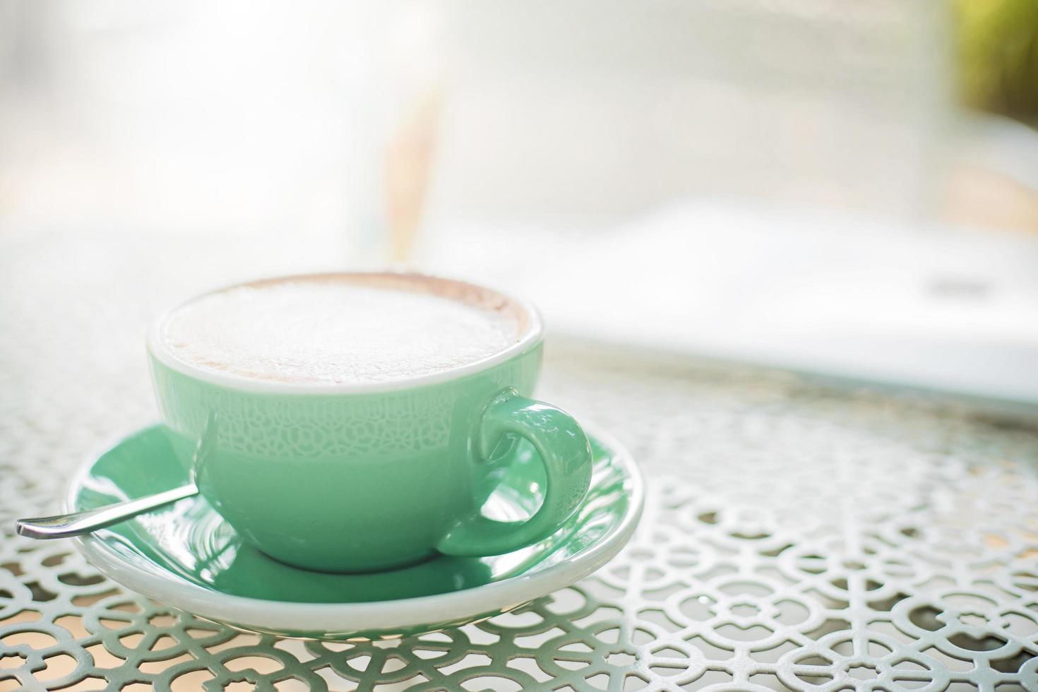 Hot coffee cup on white table photo