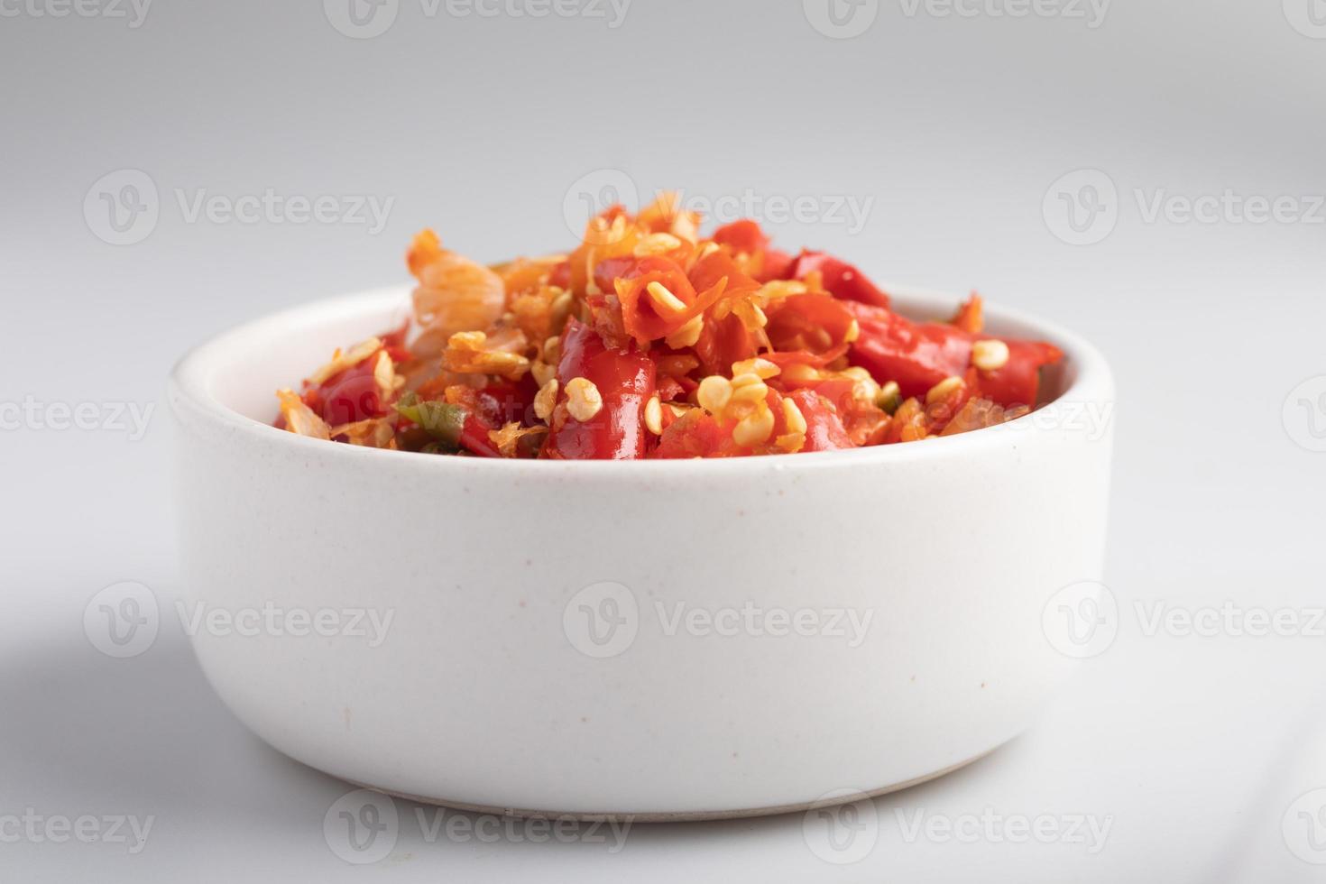 Freshly ground red chilies in a white cup photo