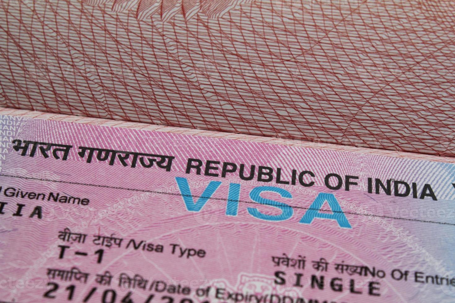 Close-up fragment of indian tourist visa in passport. Travel and tourism concept photo