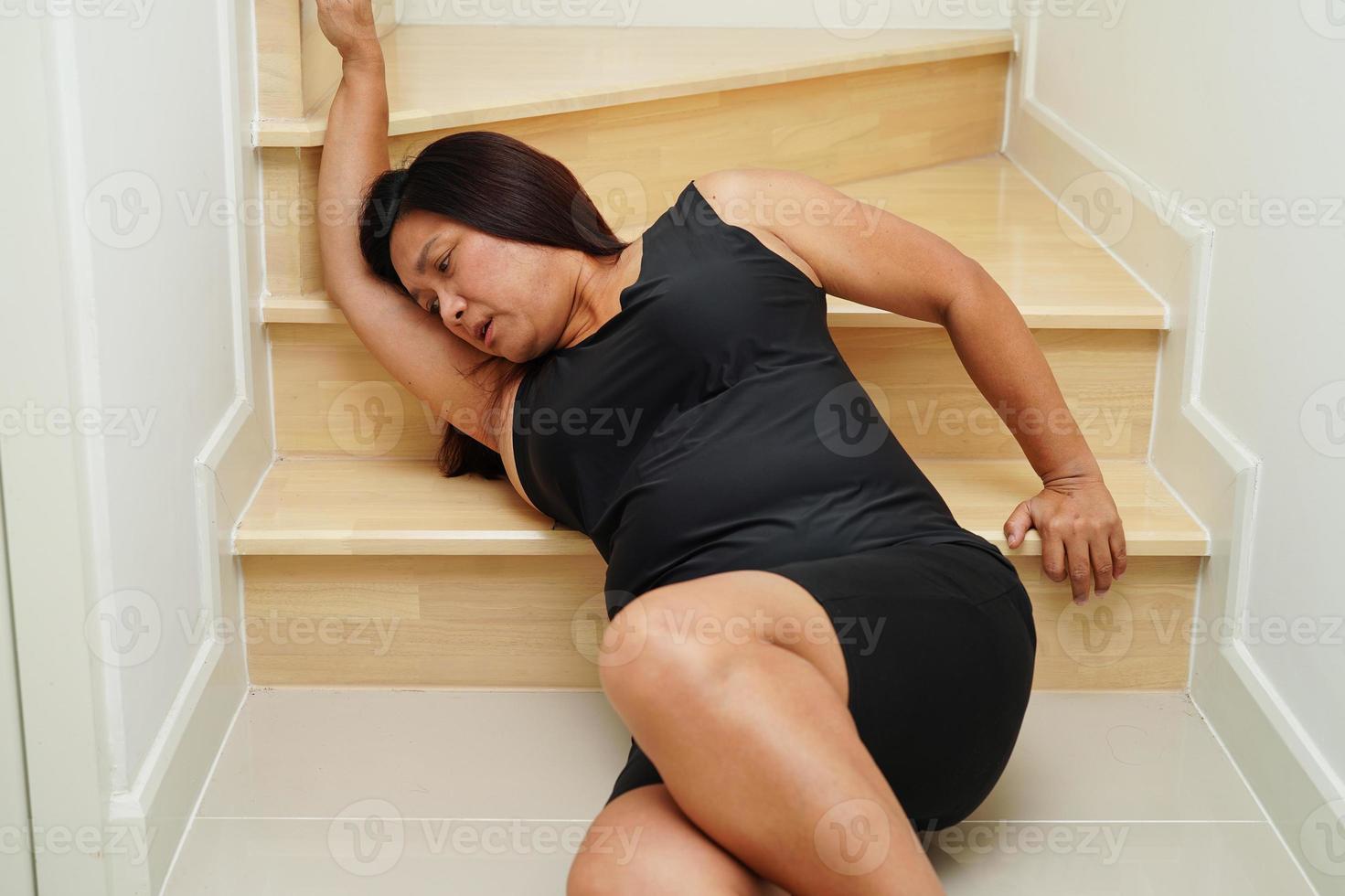 Asian woman injury from falling down on slippery surfaces with walker at home. photo