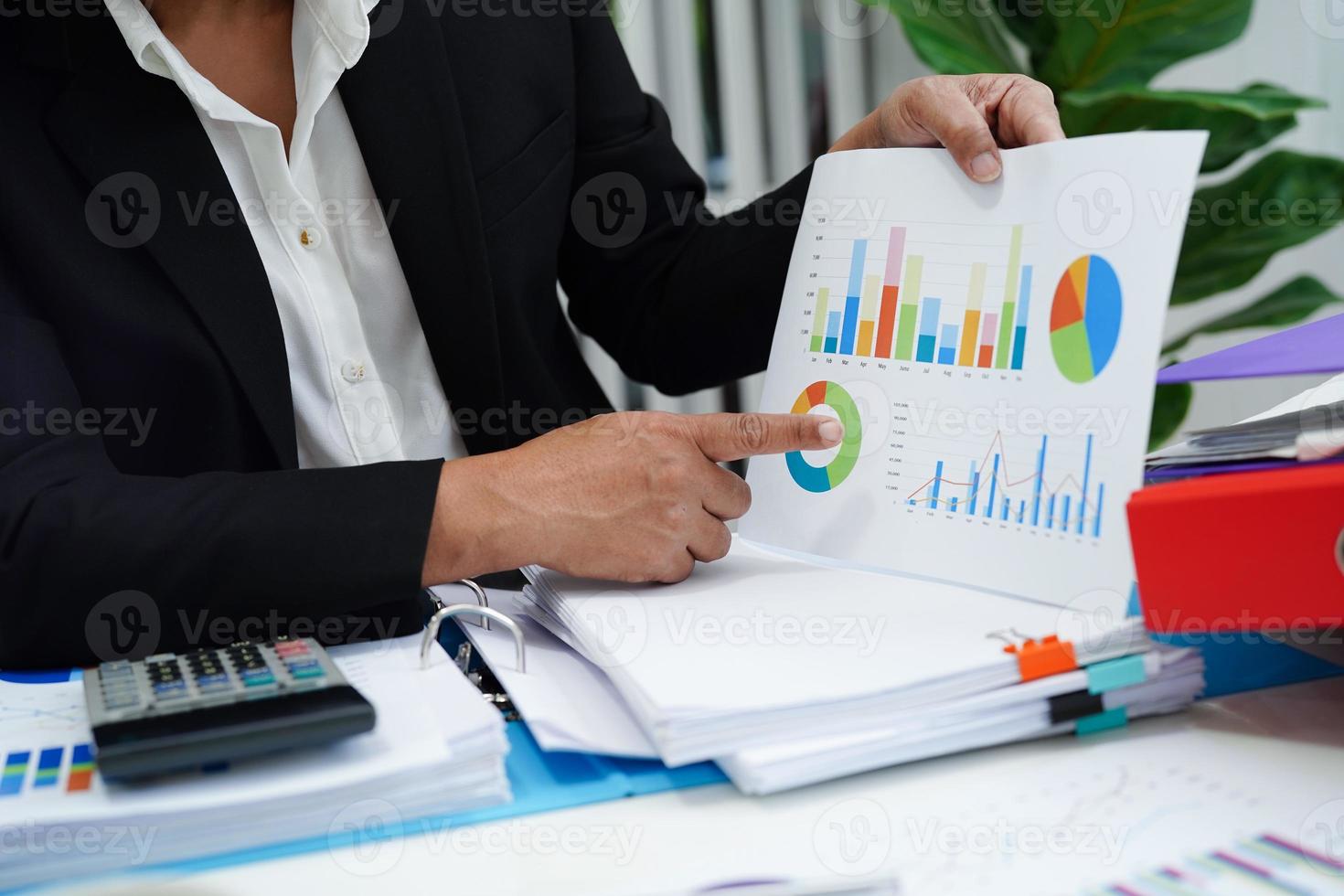 Business woman working and analysis with statistic graph in office. photo