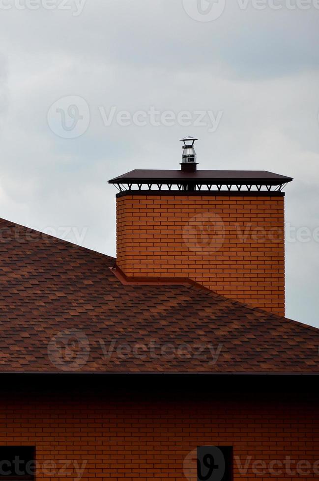 The house is equipped with high-quality roofing of shingles bitumen tiles. A good example of perfect roofing. The roof is reliably protected from adverse weather conditions photo