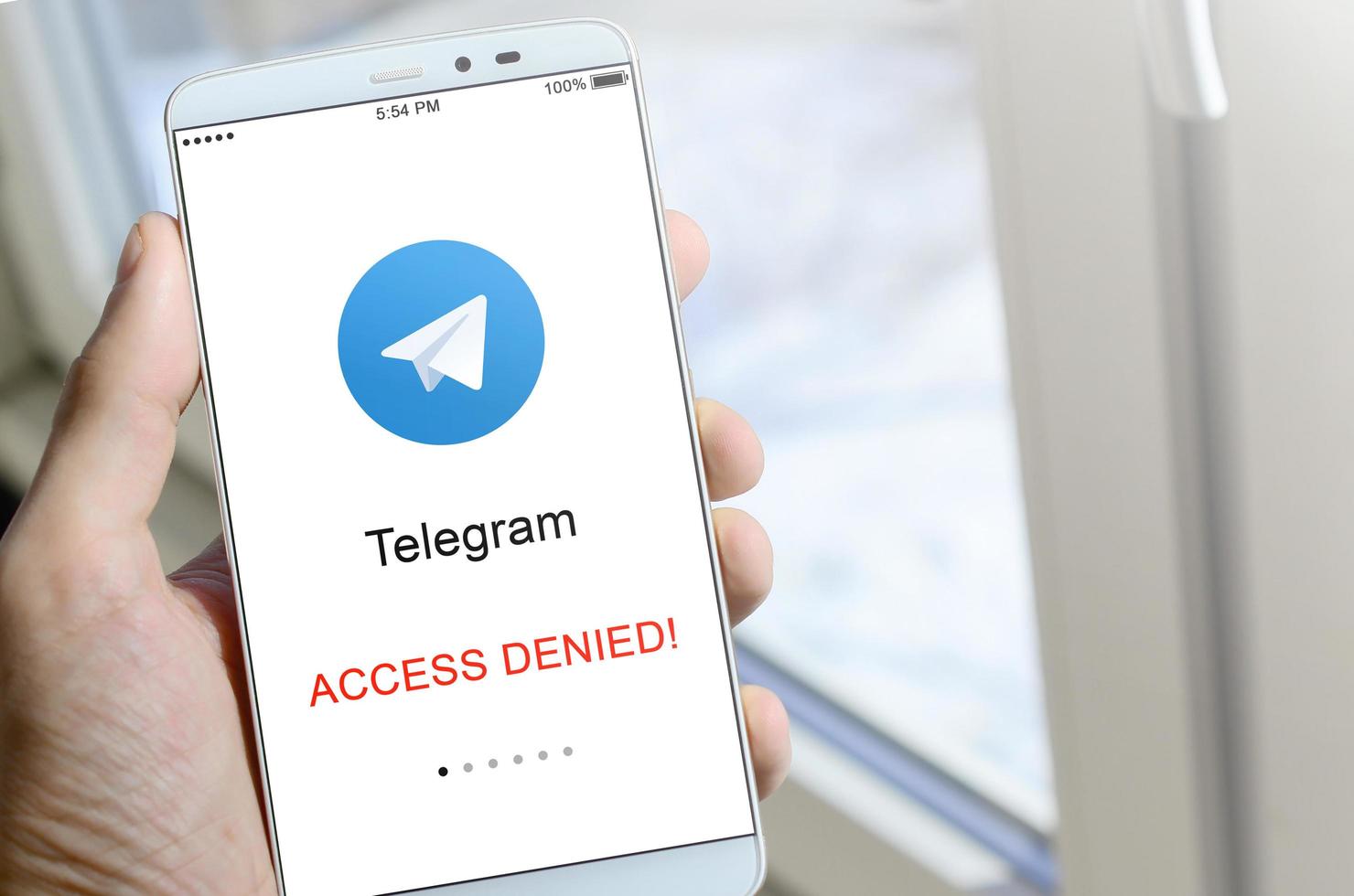 KHARKOV, UKRAINE - APRIL 27, 2022 A mobile phone with the Telegram app screen with a prohibiting sign. Roskomnadzor blocked the Telegram service in Russia. Access to telegram messenger is closed photo