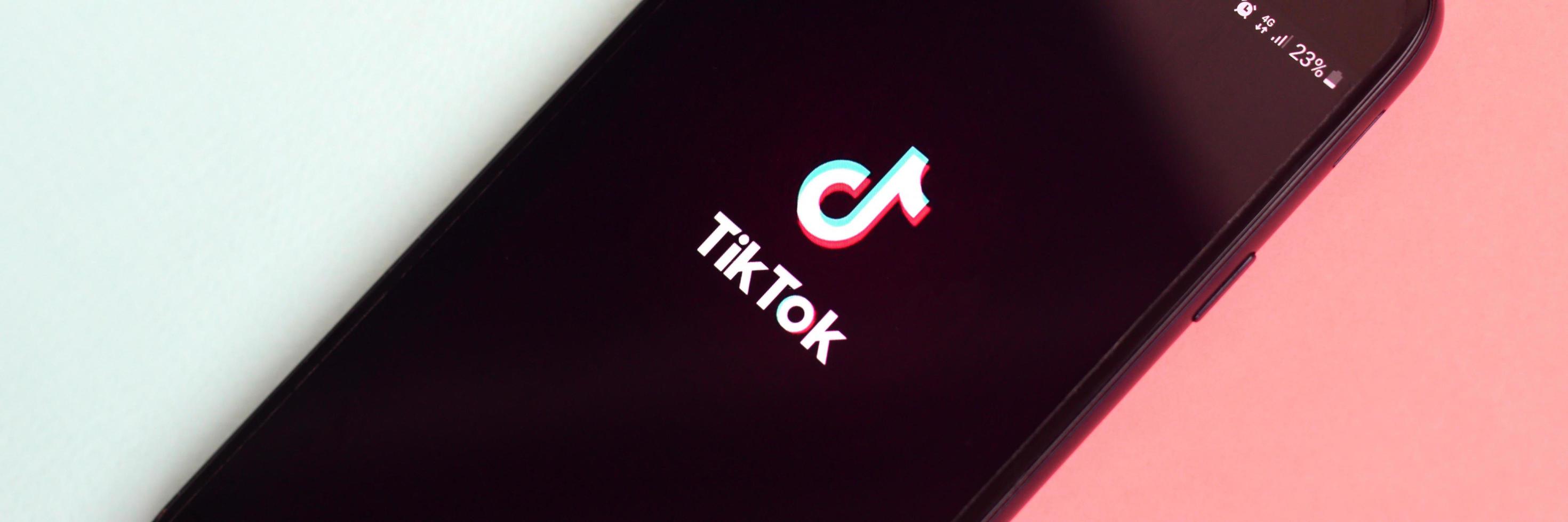 KHARKOV, UKRAINE - MAY 12, 2022 Tiktok application on samsung smartphone screen on pastel background. TikTok is a popular video-sharing social networking service owned by ByteDance photo