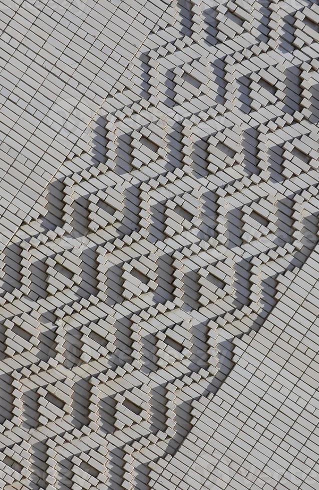 A pattern made of white bricks in the form of diamond shapes. Decoration of the walls during the Soviet Union photo