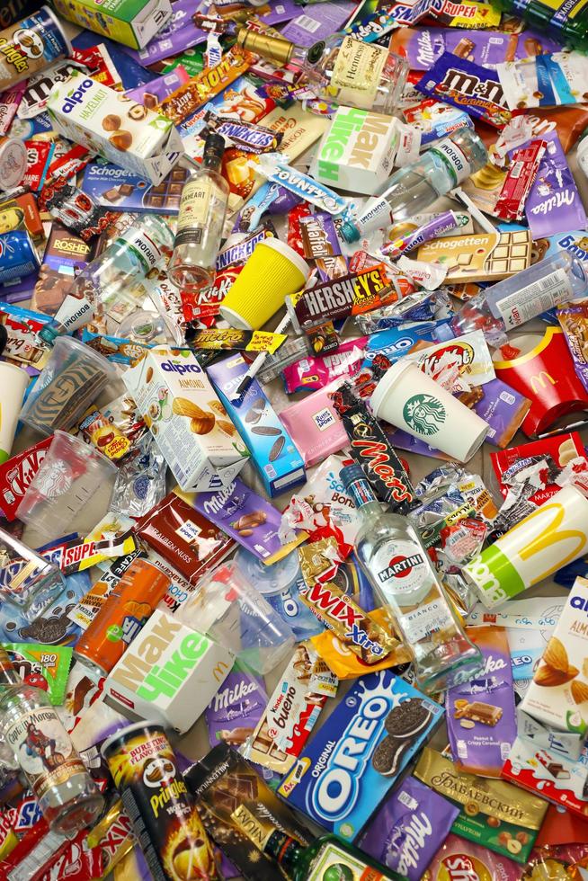 KHARKOV. UKRAINE - MAY 2, 2022 Big pile of various wrappings and empty disposable packages and cups from famous branded food production photo