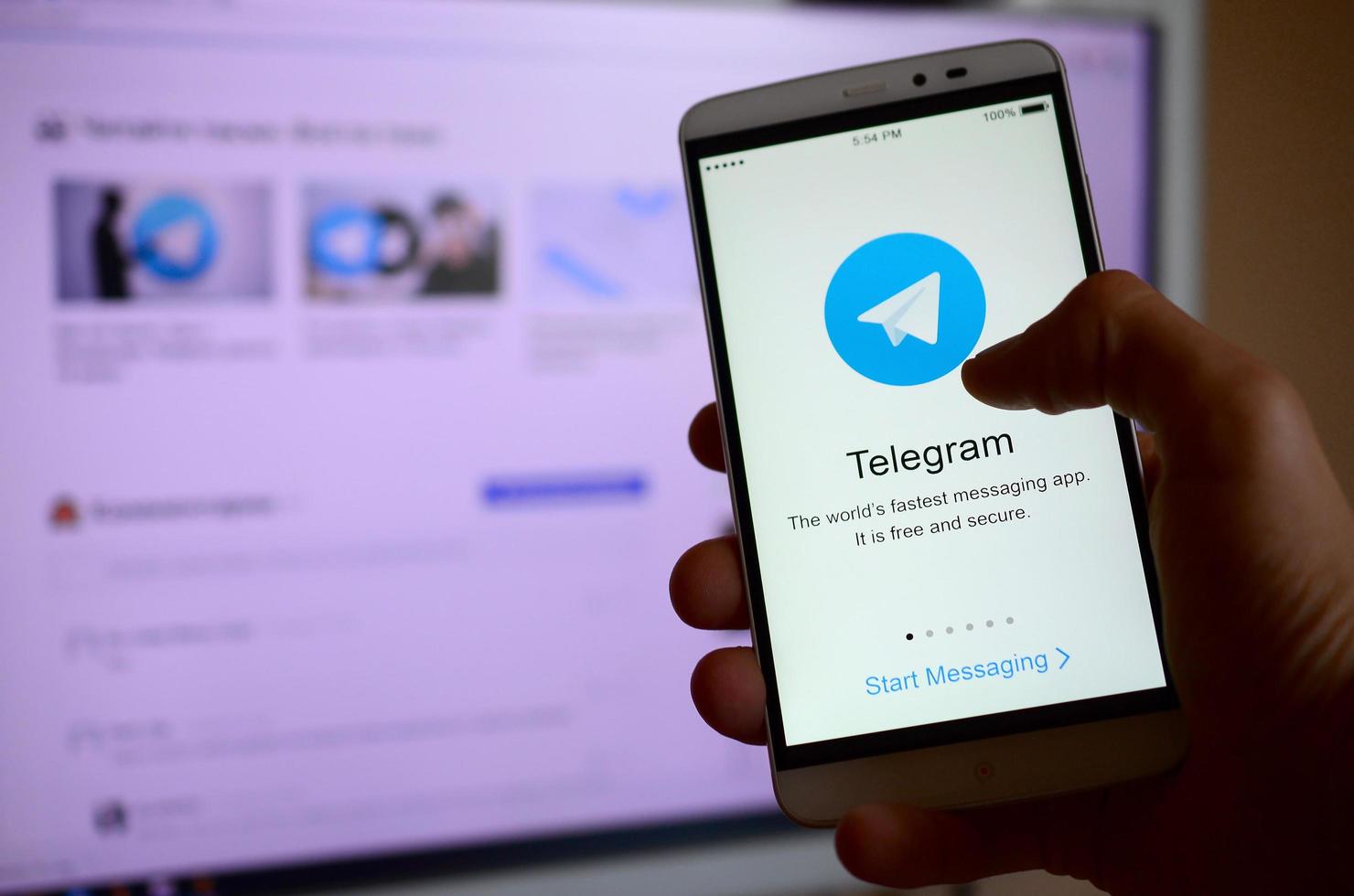 KHARKOV, UKRAINE - MAY 8, 2022 A mobile phone with the Telegram app screen in hand photo