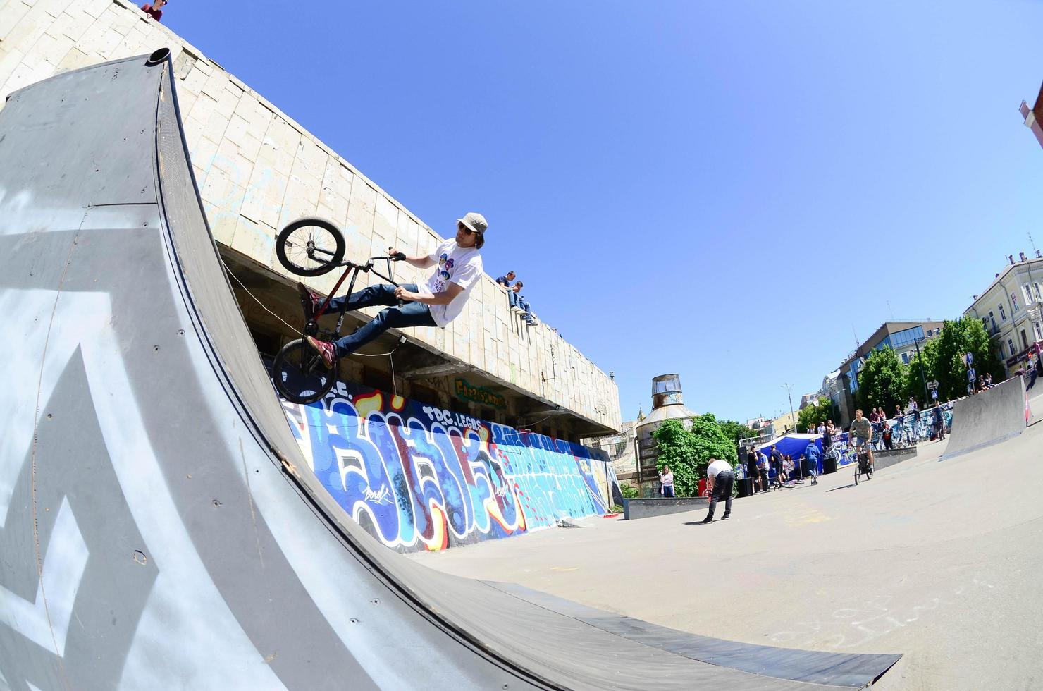 KHARKIV, UKRAINE - 27 MAY, 2022 Freestyle BMX riders in a skatepark during the annual festival of street cultures photo