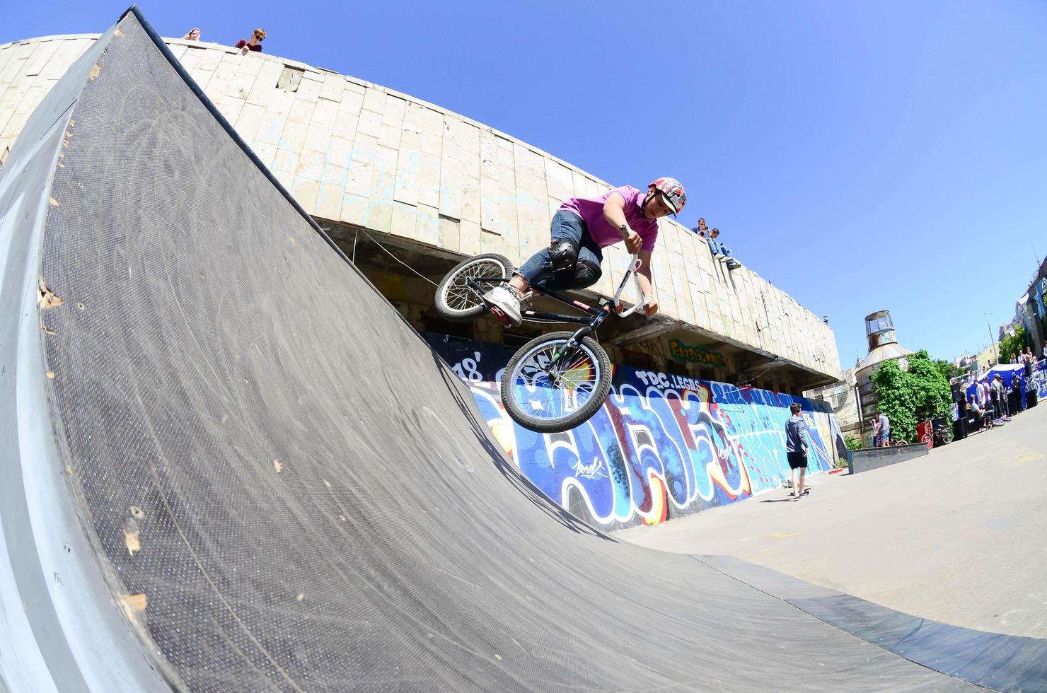 KHARKIV, UKRAINE - 27 MAY, 2022 Freestyle BMX riders in a skatepark during the annual festival of street cultures photo