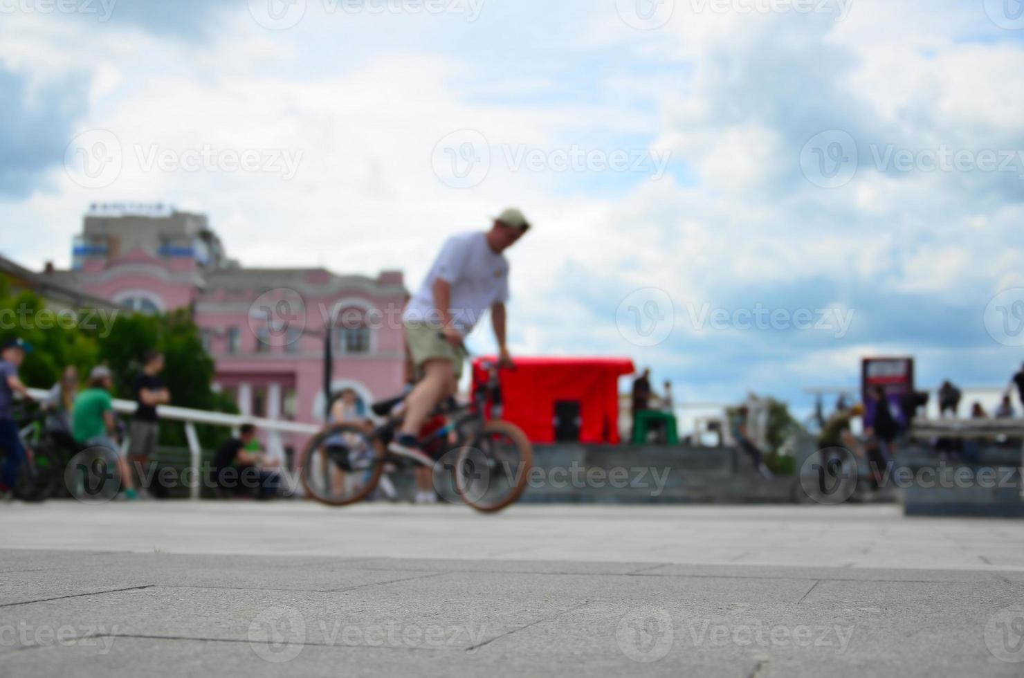 Defocused image of a lot of people with bmx bikes. Meeting of fans of extreme sports photo