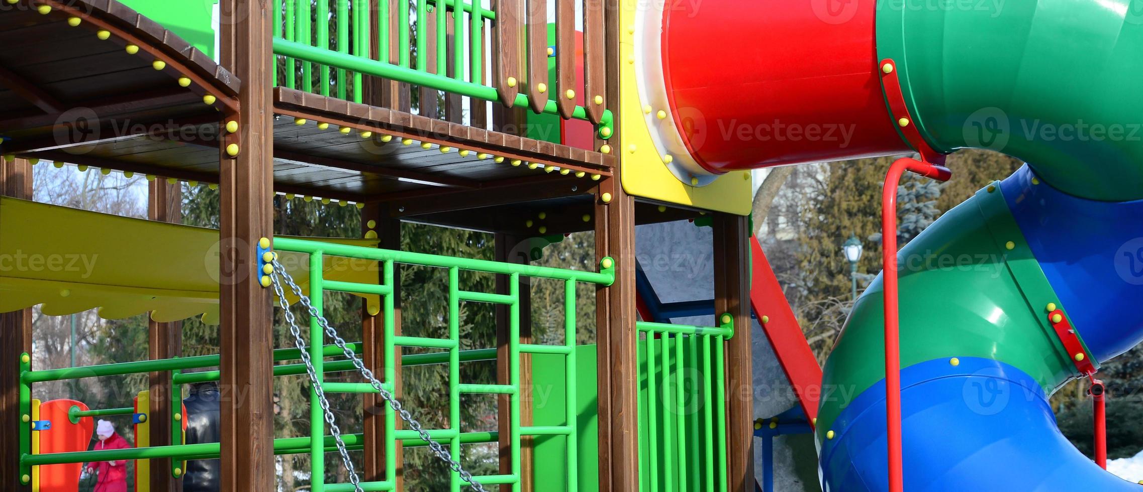 Fragment of a playground made of plastic and wood, painted in different colors photo