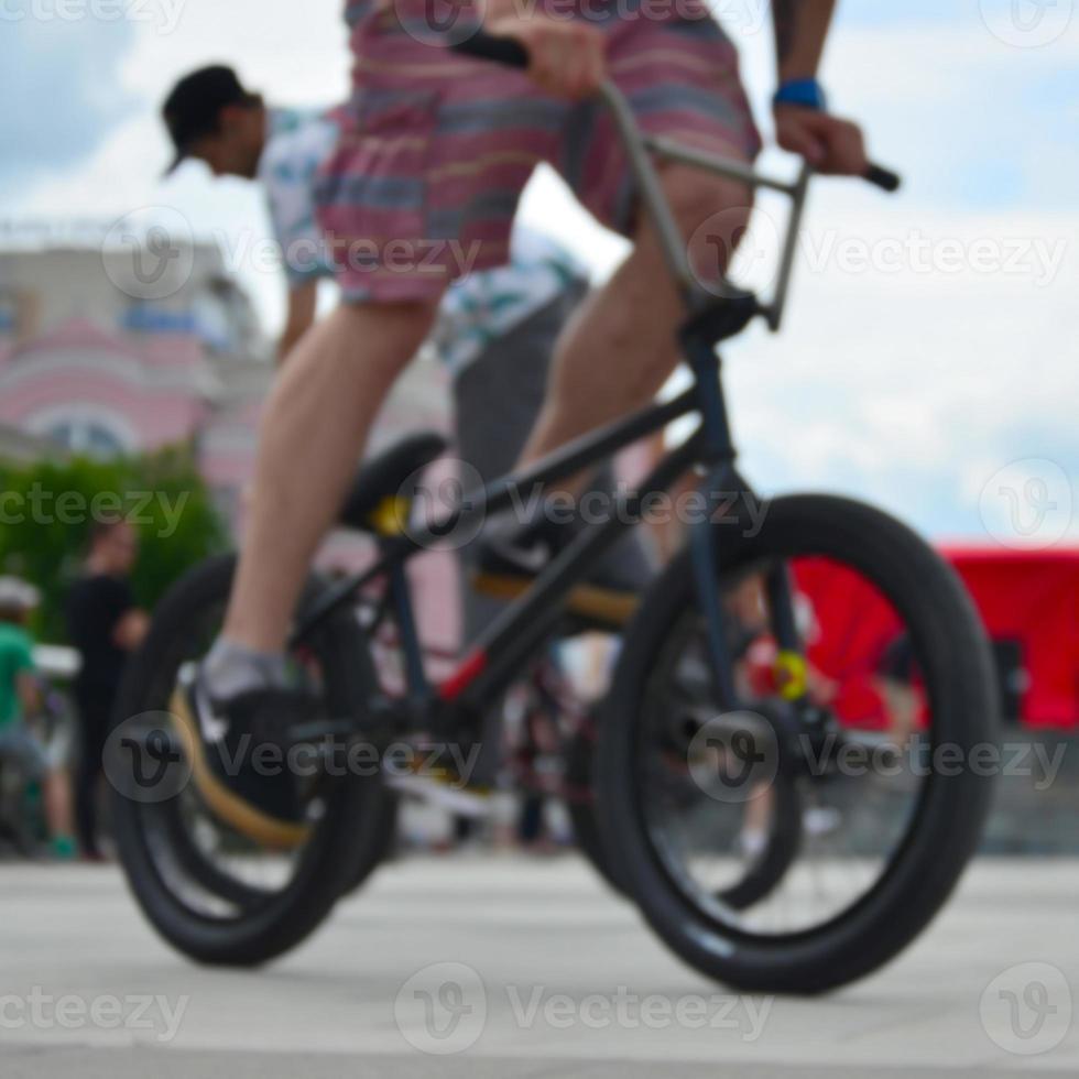 Defocused image of a lot of people with bmx bikes. Meeting of fans of extreme sports photo