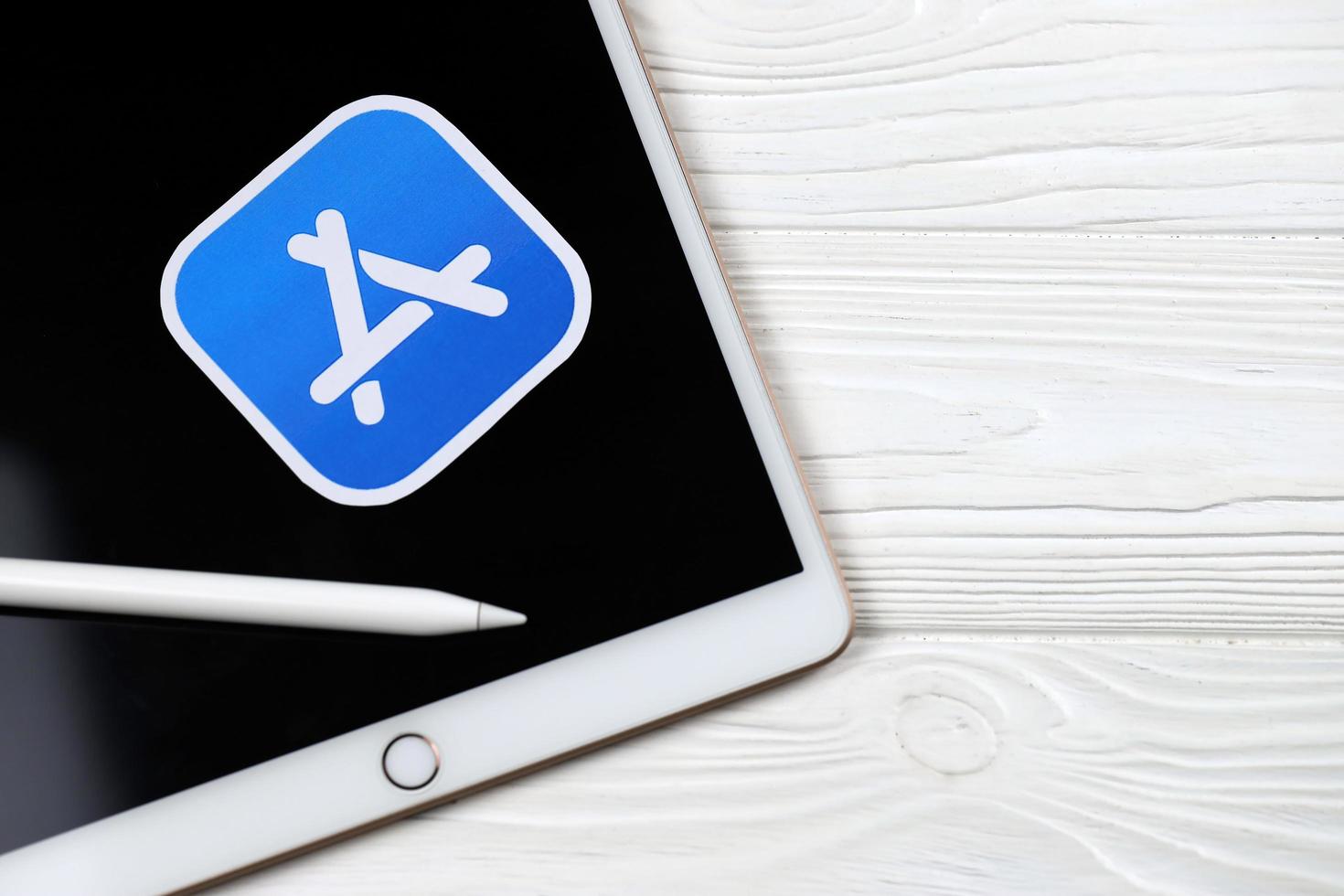 KHARKOV, UKRAINE - MAY 5, 2022 Brand new Apple iPad and Apple Pencil and blue app store logo on white background. Apple Inc. is an American technology company photo