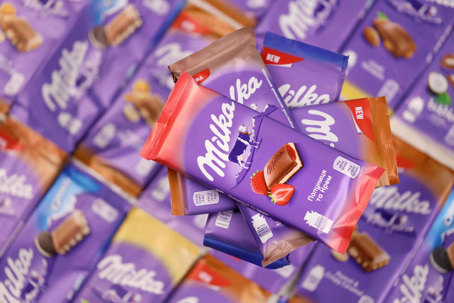 KHARKOV. UKRAINE - MAY 17, 2022 Many wrappings of purple Milka chocolate. Milka is a Swiss brand of chocolate confection manufactured by company Mondelez International photo