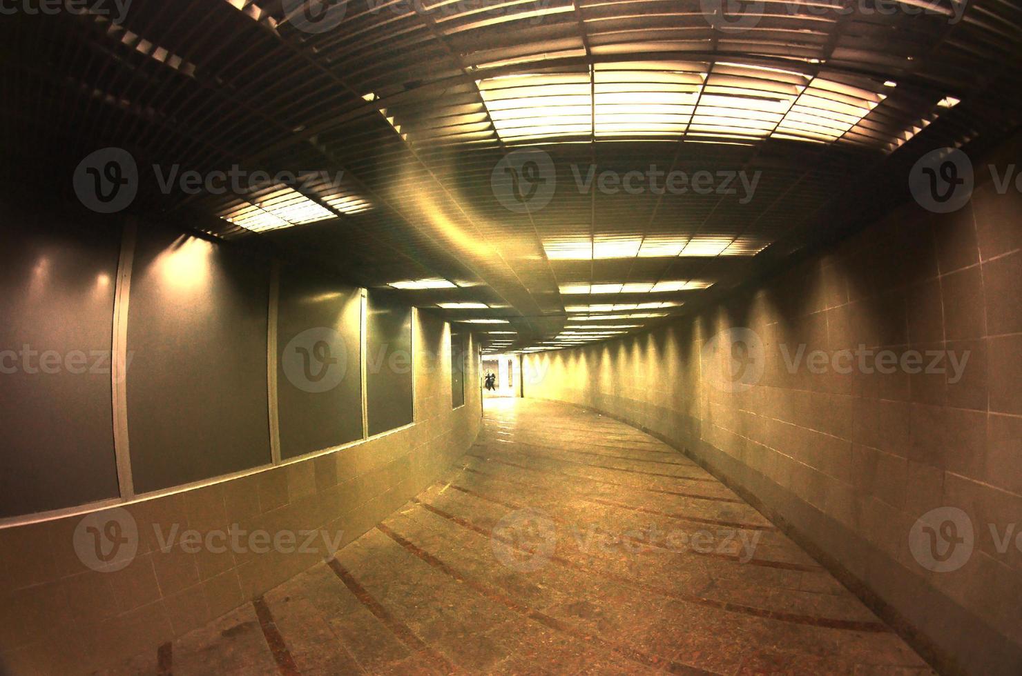 Dark interior of the underground passage with electric lighting photo