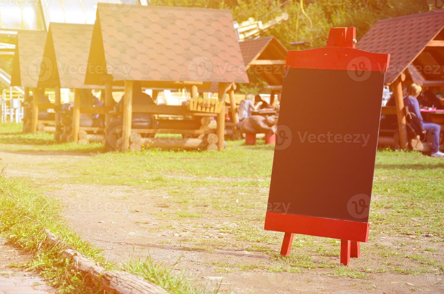A large board as a menu for an open-air restaurant in a mountainous area. Free space for your text photo