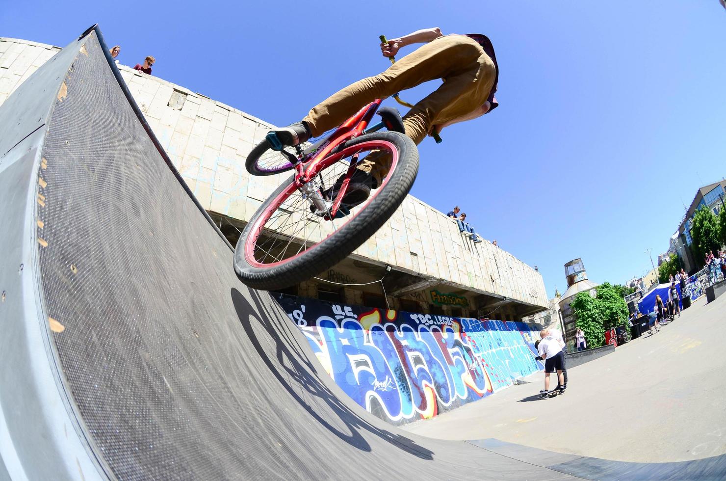 KHARKIV, UKRAINE - 27 MAY, 2022 Freestyle BMX riders in a skatepark during the annual festival of street cultures photo