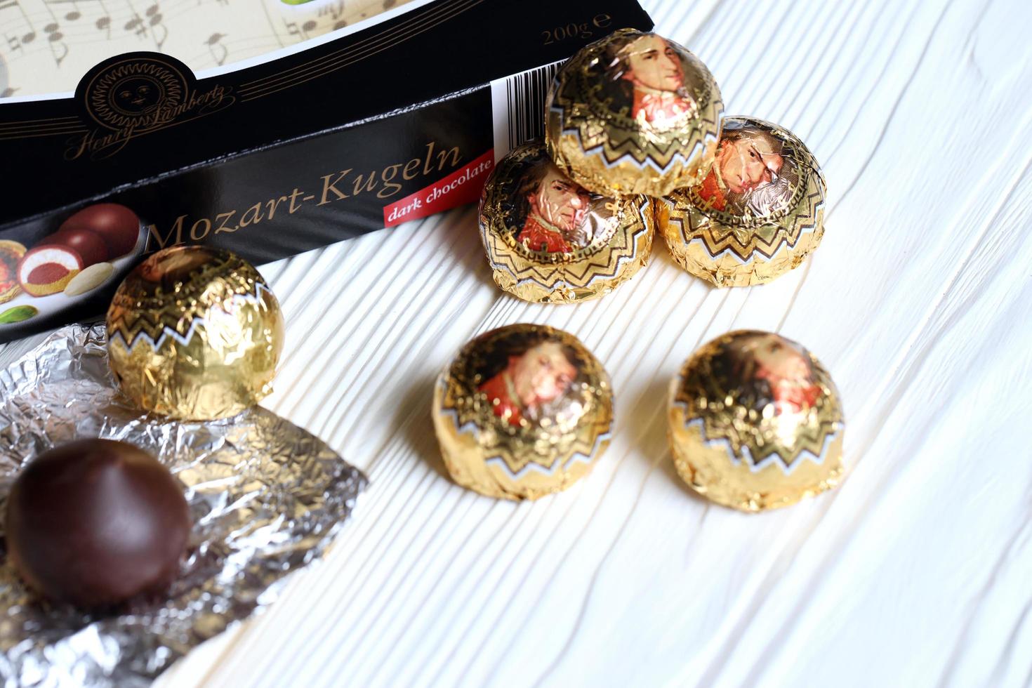 KHARKOV. UKRAINE - MAY 2, 2022 Henry Lambertz Mozart-Kugeln luxury dark chocolate candies in black box on white table photo