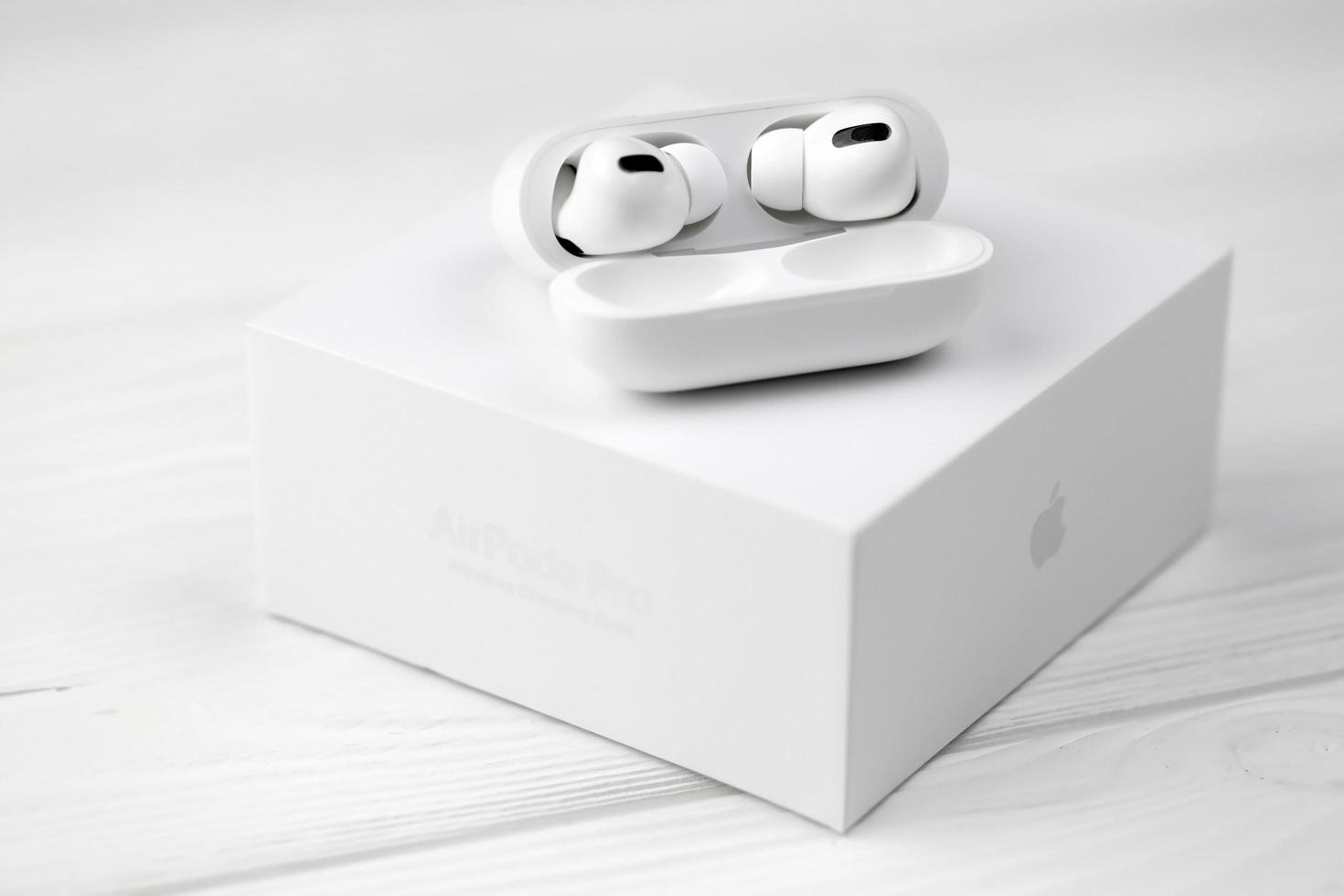 KHARKOV, UKRAINE - MAY 12, 2022 Apple AirPods Pro on a white background. Wireless headphones with charging case and a box. Apple Inc. is an American technology company photo
