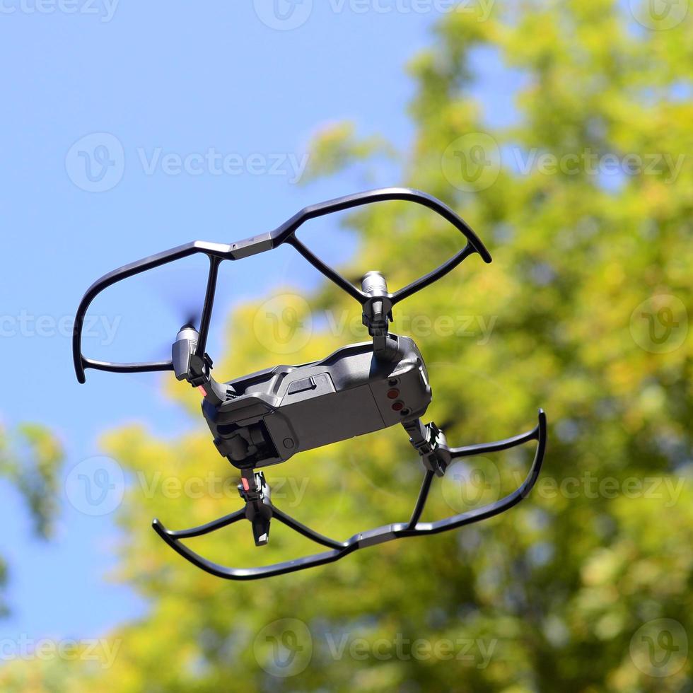 Drone with photocamera take off from land and flying for take aerial photo