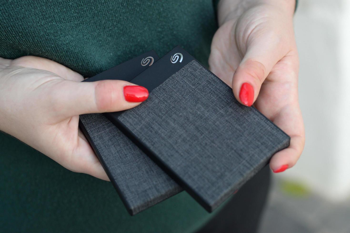 KHARKOV. UKRAINE - MAY 17, 2022 Young girl holds Seagate 1tb portable USB hard drive. Seagate Technology PLC is American data storage company was incorporated in 1978 photo