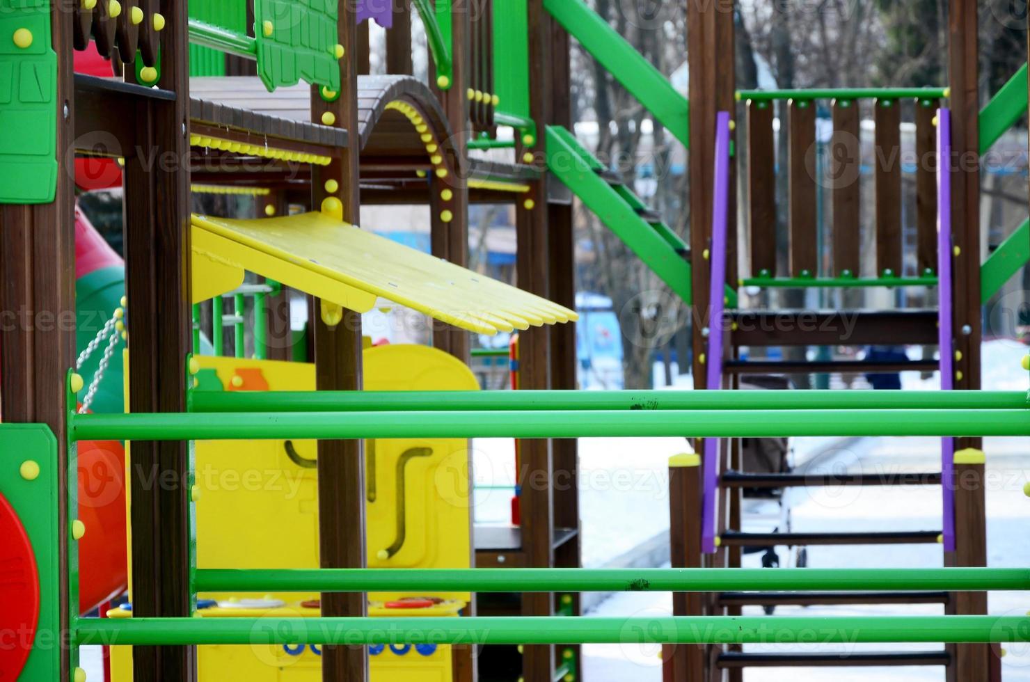 Fragment of a playground made of plastic and wood, painted in different colors photo