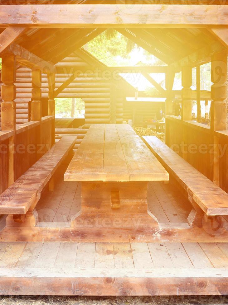 Interior of a wooden arbor handmade from dark wood in the woodland photo
