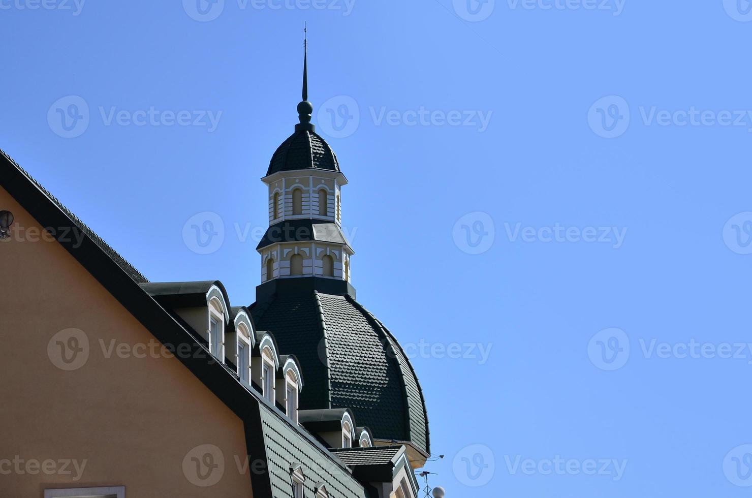 Details of Kharkov architecture close-up. Fragment of the corner of the roof of a multi-storey building, decorated in antique style photo