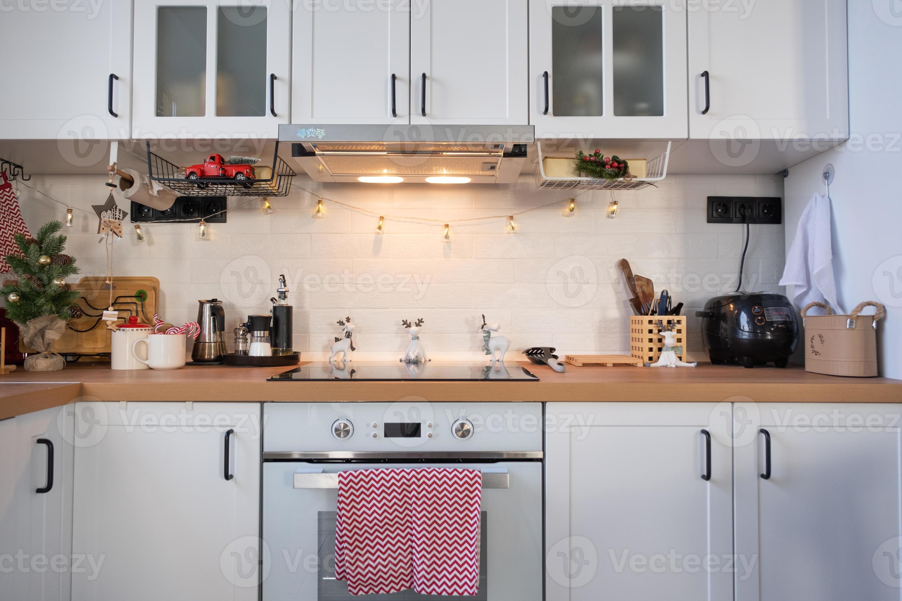 Christmas kitchen decor - preparation for a family holiday, fairy light, Christmas tree, red ornament, funny deer on cabinets, stove. Mood of celebration, eve, New year 13940920 Stock Photo at Vecteezy Christmas kitchen decor - preparation for a family holiday, fairy light, Christmas tree, red ornament, funny deer on cabinets, stove. Mood of celebration, eve, New year 13940920 Stock Photo at Vecteezy