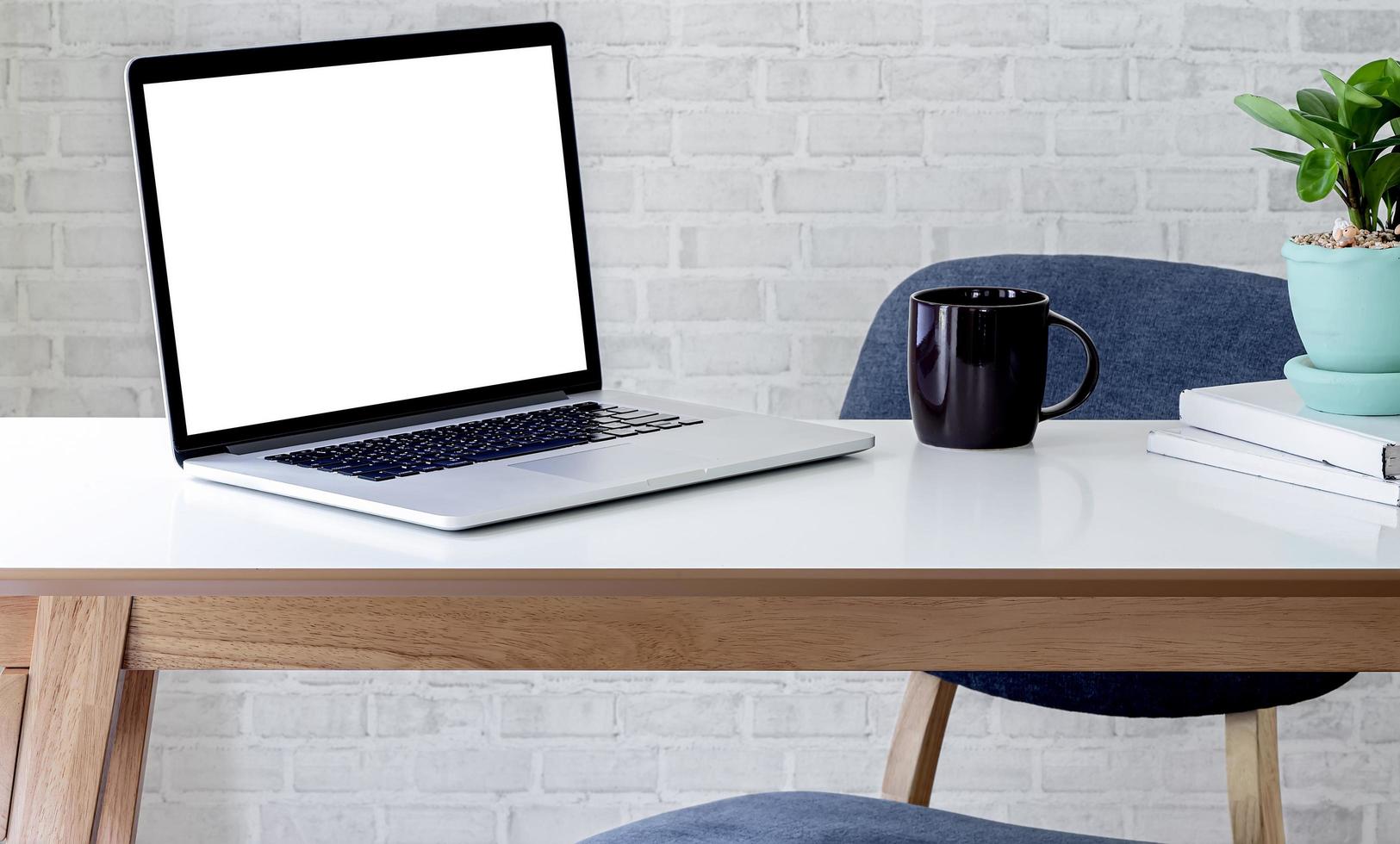 laptop in office table mock up photo