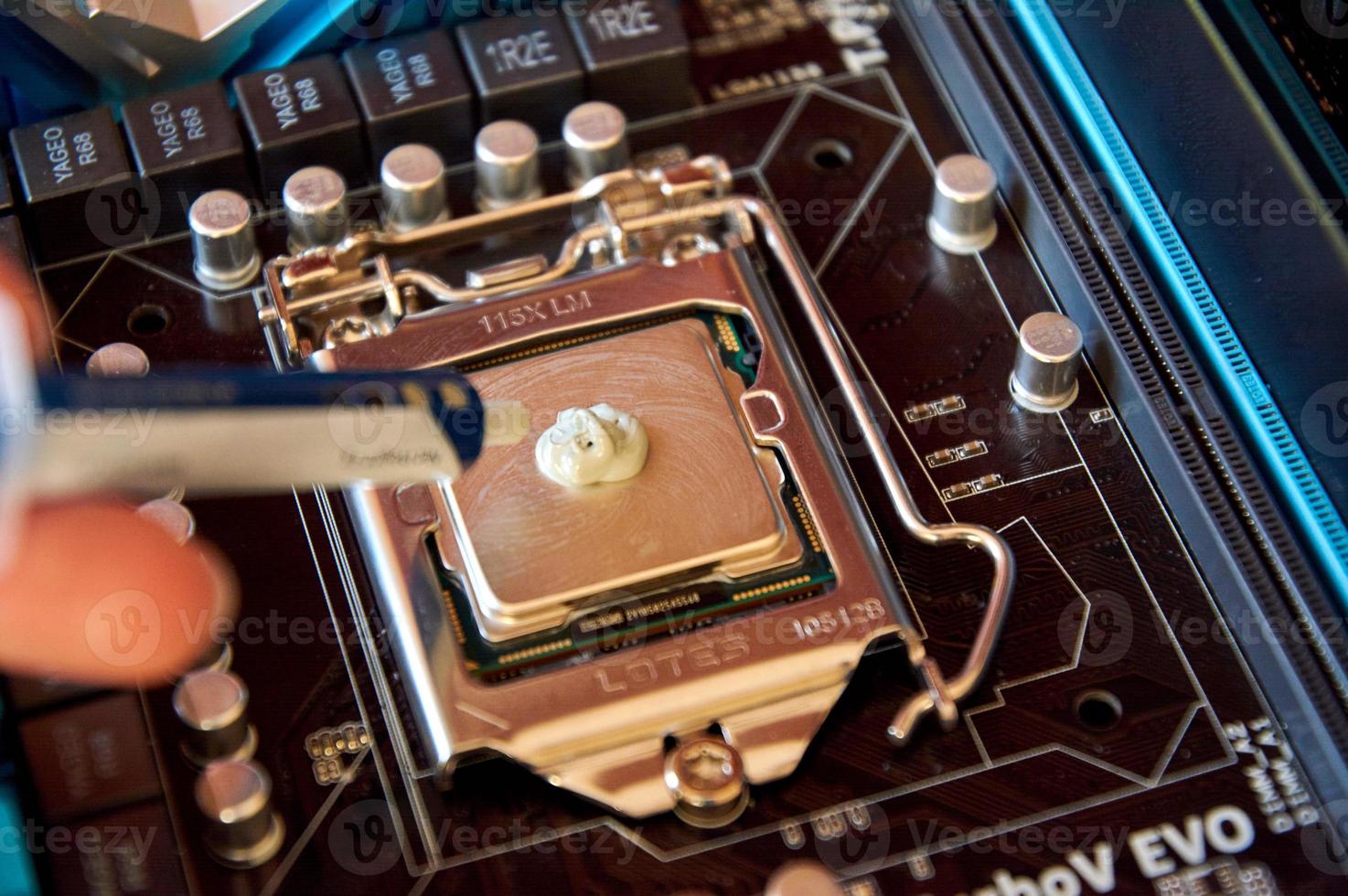 applying thermal paste to the central processor of the motherboard photo
