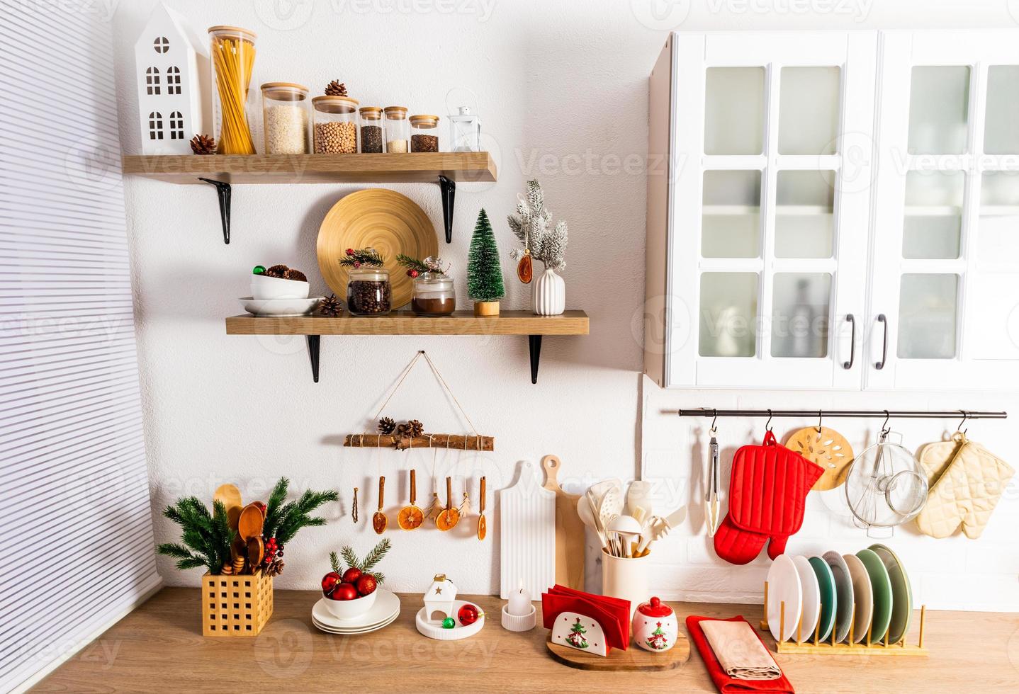 the front view of part of the modern interior of the kitchen with items and eco decorations made by their own hands for the new year. photo