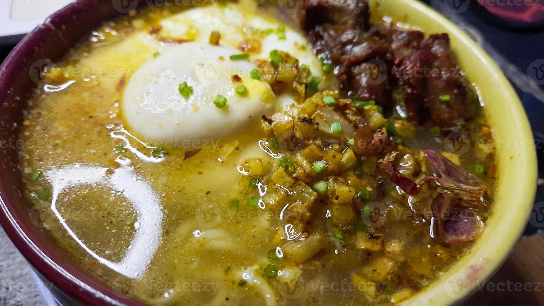 Close up, Curry-flavored instant noodles, topped with egg and fried chicken photo